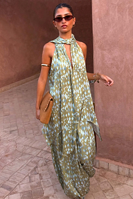 Green Diamond Print Halter Top in olive satin with a draped scarf and asymmetric hem, styled with matching trousers.