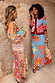 Blue Dolce Vita Dorris midi skirt with red wave and sun motifs, styled with a matching cardigan.