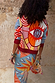Dolce Vita Hollie Cardigan with an oversized eye print, swirling motifs and burgundy ribbed trims from behind.