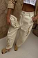 Thumbnail for Ecru Raffia Palma Barrel Leg Jeans with palm embroidery, styled with a beige jacket and raffia clutch.