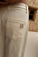 Ecru Raffia Palma Barrel Leg Jeans showing the brown embroidered NFD logo on the back pocket.
