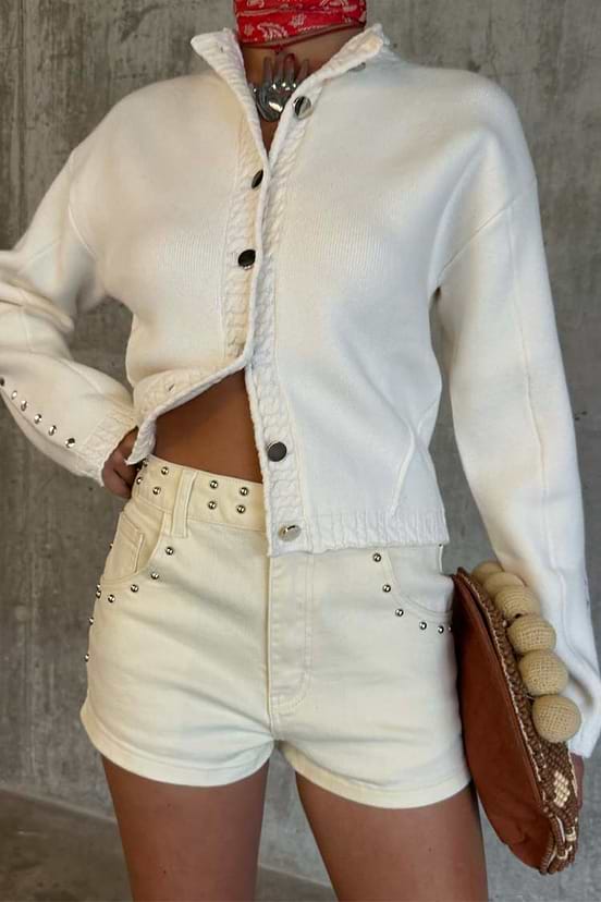 Ecru Studded Hot Pant featuring silver stud detailing on cream denim, styled for a festival look.