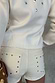 Ecru Studded Hot Pant with silver details on back pockets, paired with a matching cream top.