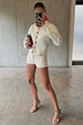 Ecru Studded Hot Pant in cream cotton with silver studs, paired with a matching jacket and heels.