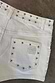 Ecru Studded Hot Pant back pocket detail with silver studs on a cream cotton base and tonal embroidery.