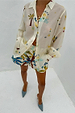 Palm Elissa Shorts in a cotton-linen blend with a multi-coloured palm leaf print, styled with a coordinating shirt.