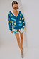 Thumbnail for Palm Elissa Shorts in a cotton-linen multi-colour palm print, styled with a blue motif cardigan and heels.