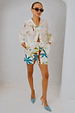 Palm Elissa Shorts in a multi-coloured palm leaf print with an elasticated waistband, styled with a matching shirt.