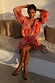 Peach orange Blurred Floral Ella Mini Dress featuring flute sleeves and a tiered ruffle skirt, styled outdoors.