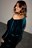 Emerald Velvet Tilly Dress featuring an off-the-shoulder neckline and sparkly velvet on a smiling model.