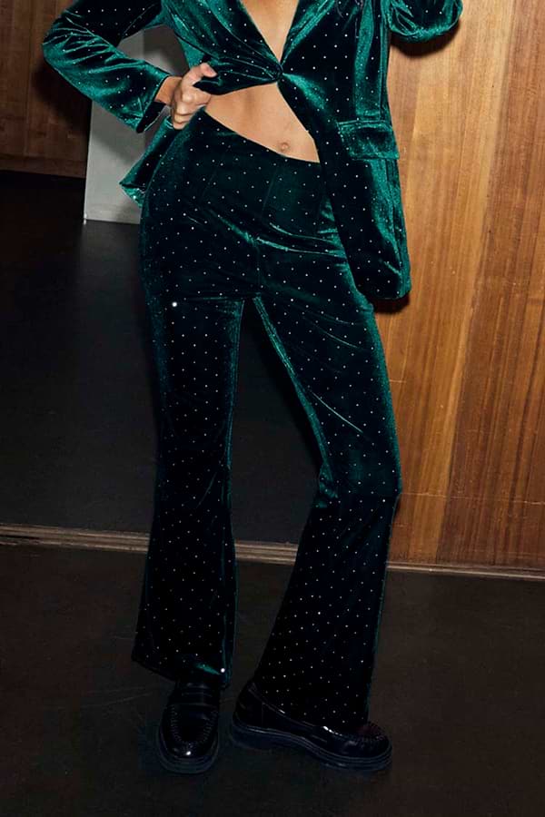 Emerald Velvet Trousers with diamond studs, styled with a matching blazer and black loafers.