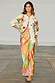 Multi Enchanted Cardigan in a cream knit with sun motifs and multi-colour trim, styled with a patterned maxi skirt.