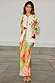 Multi Enchanted Cardigan in cream with colourful motifs and multi-coloured trim, styled over a patterned maxi skirt.