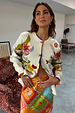 Cream Multi Enchanted Cardigan featuring colourful NFD motifs and multi-coloured trim, styled over a vibrant wrap skirt.