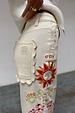 Ecru Enchanted Cut Work Scallop Jeans with a scalloped back pocket and colourful embroidered sun motif.