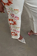 Ecru Enchanted Jeans featuring sun and abstract motif embroidery on cotton denim.