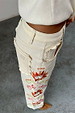 Ecru Enchanted Cut Work Scallop Jeans featuring colourful embroidery and scalloped edge pockets.