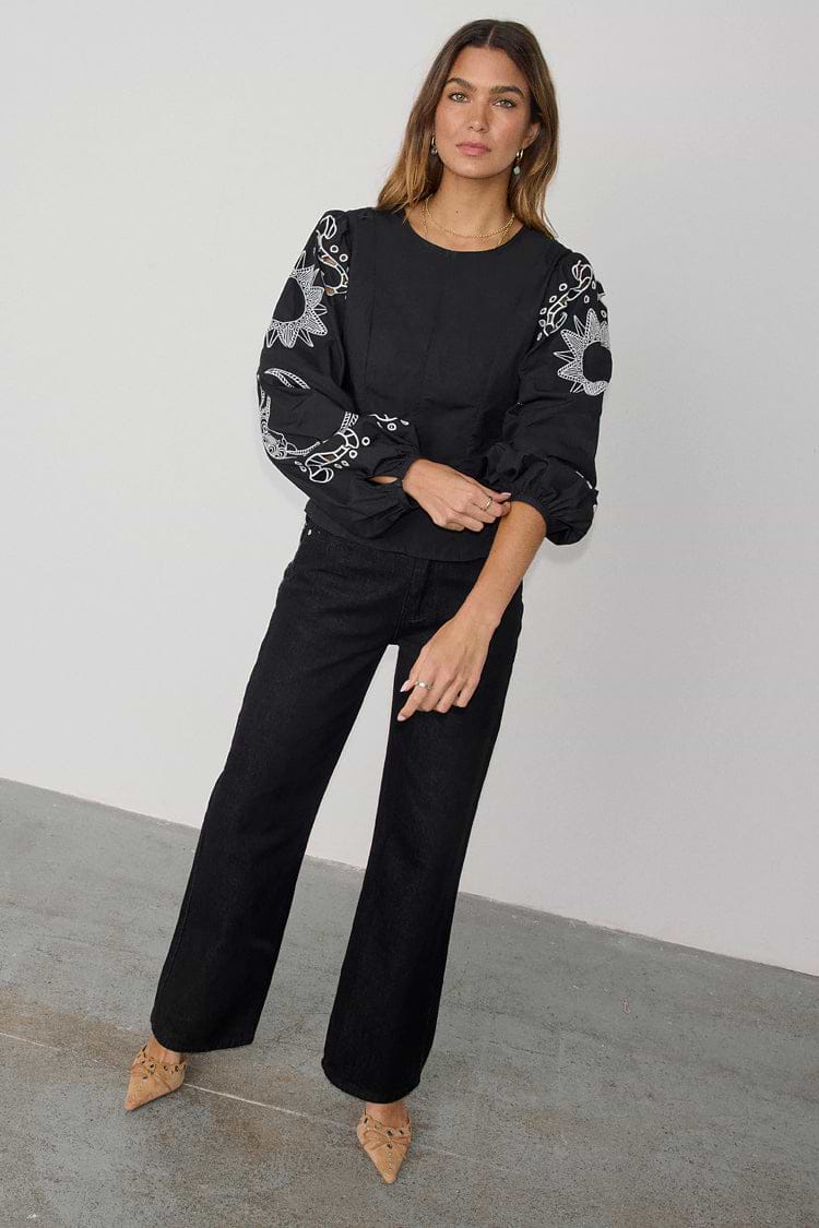 Black Enchanted Lillie Top with white embroidered blouson sleeves and a fitted cotton silhouette.