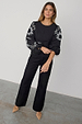 Black Enchanted Lillie Top with white embroidered blouson sleeves and a fitted cotton silhouette.