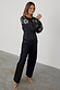 Black Enchanted Lillie Top featuring white embroidered blouson sleeves and a fitted cotton silhouette.