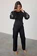 Black Enchanted Lillie Top featuring embroidered blouson sleeves and fitted waist panels, styled with black jeans.