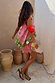 Etta Hankerchief Hem Top in a pink and green multi print, styled with a pink lace skirt and beaded clutch.