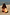 Thumbnail for Girl's Yellow Sun Swimsuit with sun print and frill detailing on a young girl crouching on a beach.