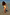Thumbnail for Girl's Yellow Sun Swimsuit with a playful sun print and soft frill trims on a girl standing in shallow water.