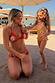 Girl's Yellow Sun Swimsuit with frill trim and sun print, paired with a matching adult bikini on a beach vacation.