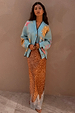 Brown Fawn Midi Maeva Skirt with an intricate lace border, paired with a light blue graphic cardigan.