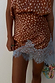 Fawn Mini Maeva Skirt with a brown animal print and blue lace border at the hem.