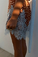 Fawn Mini Maeva Skirt in a brown spot print with an intricate light blue lace border and matching sash.