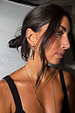 Deloris Sardine Earrings featuring mixed-metal fish pendants on gold hoops, worn by a model in a black tank top.