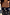 Thumbnail for Deloris Sardine Necklace featuring a polished brass fish pendant on a long chain, layered over a palm-embroidered swimsuit.