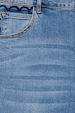 Blue Denim Flare Scallop Jean detail with a navy scalloped pocket trim and contrasting gold stitching.