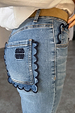 NFD Denim Flare Scallop Jean in blue with navy scalloped pockets and an embroidered logo on the back.