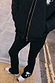 Black Cotton Wide Leg joggers with ecru embroidery motifs at the hem, styled with a quilted jacket for a London look.