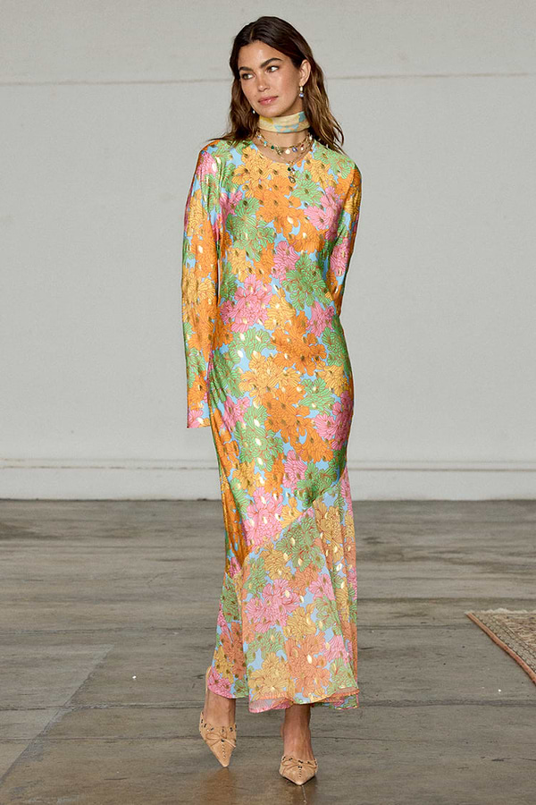 Floral Alaia Dress in a multicoloured print with gold flecks, bell sleeves and an asymmetric skirt.