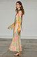 Multicoloured Floral Alaia Dress featuring gold flecks, bell sleeves and an asymmetric hem in a side profile.