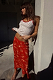 Red Floral Midi Skirt with a floral print, paired with a white pointelle vest for a vacation look.