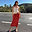Red floral midi skirt in viscose, styled with a floral pointelle lace vest on an outdoor sunny road.