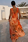 Burnt orange Blurred Floral Sofia Dress featuring a deep V-back and tie-knot shoulder details.