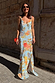 Sky Blue Floral Sofia Dress featuring tie knot shoulders and a side slit, worn by a model against a stone wall.