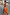Thumbnail for Burnt orange Blurred Floral Sofia Dress with tie-knot shoulders and a side slit, styled for a summer vacation.