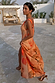 Burnt orange Blurred Floral Sofia Dress with tie-knot shoulders and a side slit, styled for a summer vacation.