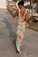 Sky Blue Floral Sofia Dress featuring a low back and side slit, shown on a model in a sun-soaked vacation setting.