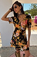 Thumbnail for Black Sofia Mini Tea Dress with orange floral print and frilled hem, designed in London for a vacation.