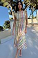 Fiesta Remi Midi Dress in a multicoloured geometric print with frilled sleeves and asymmetric hem, styled for vacation.