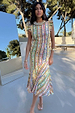 Fiesta Remi Midi Dress in a multicoloured geometric print with frilled sleeves and asymmetric hem, styled for vacation.