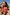 Thumbnail for Girls Pink Fruit Crop Bikini Set with a shirred bandeau top and frill bottoms on a girl at the beach.